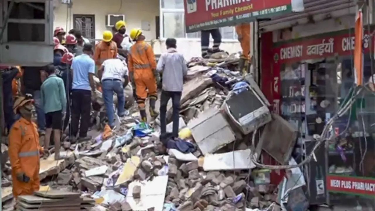 Rescue operation underway after a building collapsed at Satya Niketan area, in New Delhi. Pic/PTI